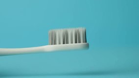 Close up view of toothpaste with toothbrush. Applying white toothpaste on a toothbrush, slow motion, 4k 