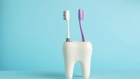 Hand takes toothbrush from toothbrush holder tooth, close-up. Healthcare, dental hygiene 4k