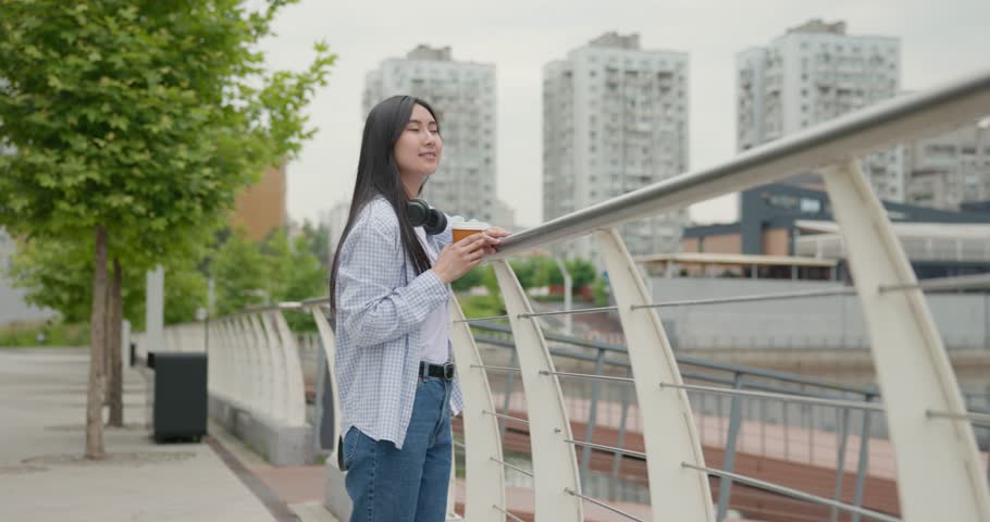 Young asian woman wearing casual clothes with backpack on the back walking at the city