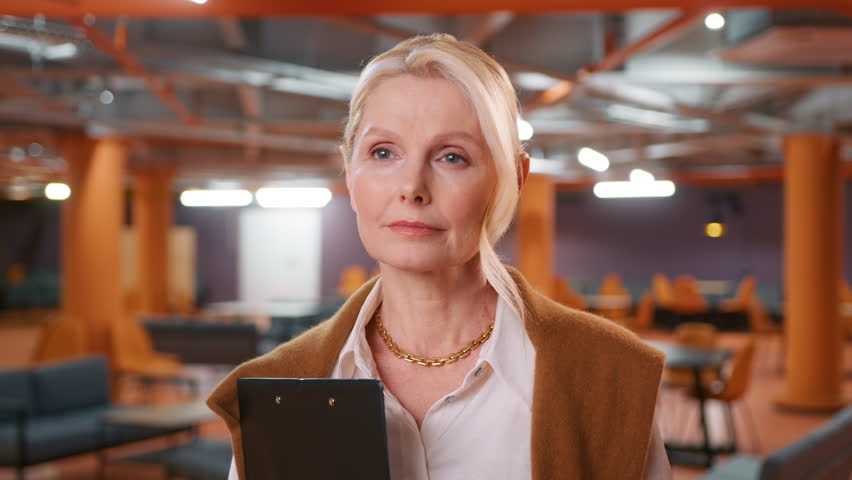 Focused business woman thinking through partnership terms, business agreement, considering partnership offer or job opportunity. Portrait of beautiful mature elegant lady boss looking aside to partner