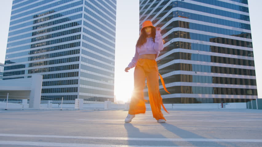 Funny girl performing cool dance at glass office buildings background. Concept of hip hop and break dance performance for music video. Youth subculture contemporary choreography cinematic RED camera | Shutterstock HD Video #1110142135