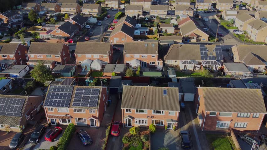 Drone 50fps. Middle class suburban housing estate development. Rooftops, gardens, solar panels. Council housing, social housing developments. Yorkshire.UK. Royalty-Free Stock Footage #1110143539