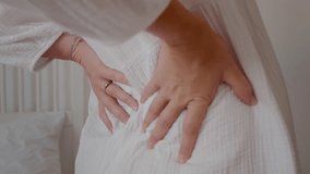 Young pregnant woman stretching back muscles and touching her belly. Backache in third trimester big belly and muscles tension in lower back. - Powered by Shutterstock - Get 15% off with code: PIKWIZARD15