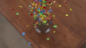 Above Many Chocolate Lentils Falling into a glass Bowl in slow motion - Powered by Shutterstock - Get 15% off with code: PIKWIZARD15