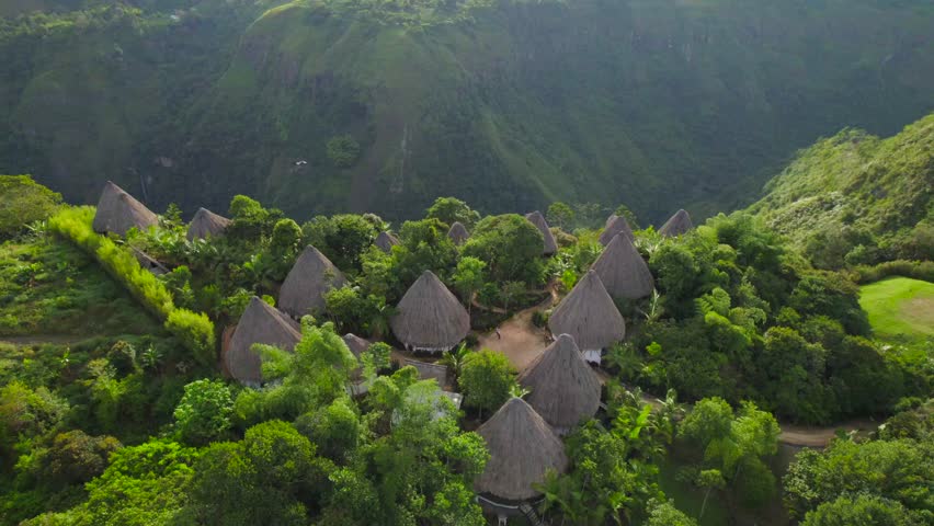 Wooden hut eco-hotel on the edge of a canyon jungle in Colombia at sunset. Aerial view Royalty-Free Stock Footage #1110175069