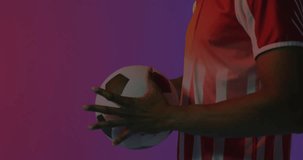 Animation of yellow football pitch and smoke over african american male football player holding ball. Digital interface, data, communication, competition and sport digitally generated video.