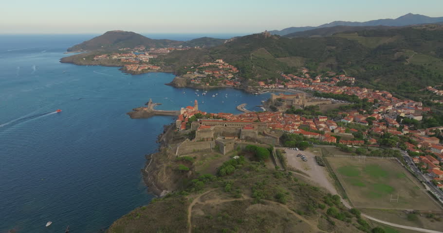 South of France, Aerial view Collioure, town near Perpignan. Port d'Avall beach and Royal castle on the left and lighthouse on the right. Drone aerial view above the sea Royalty-Free Stock Footage #1110178071