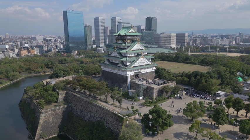 Rising view of Osaka Castle with Osaka skyline in background Royalty-Free Stock Footage #1110186693