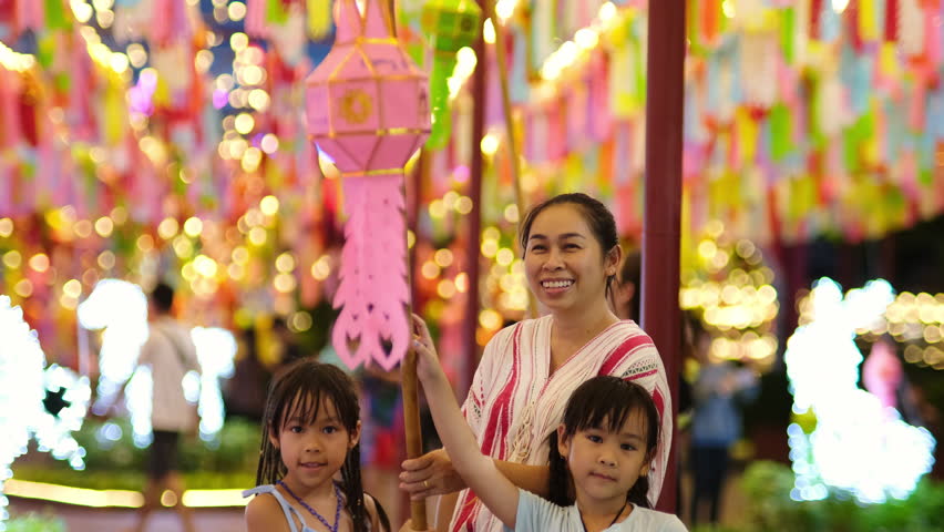 Asian families make wishes and hang lanterns during The Hundred Thousand Lantern Festival or Yi Peng Festival in northern Thailand. Royalty-Free Stock Footage #1110187353