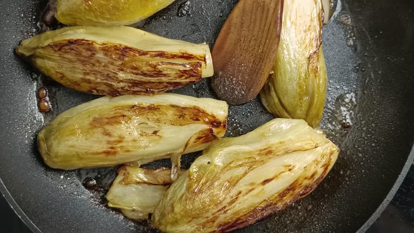 braised endives in a pan, close-up