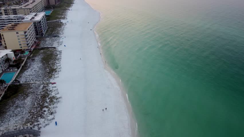 Early morning empty beach in Okaloosa Island Beach in Destin Fort Walton Beach, Florida. Aerial view of Hotels and Resorts on the beachfront of Gulf of Mexico.