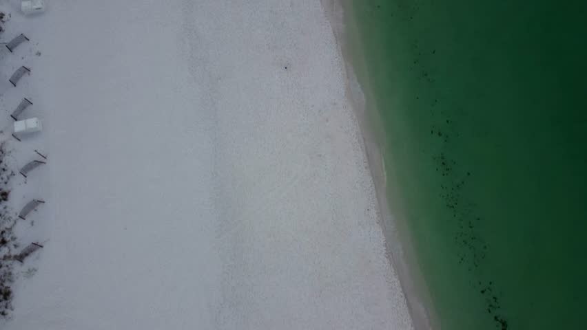 Empty beach morning walk Okaloosa Island Beach in Destin Fort Walton Beach, Florida. Aerial view of Hotels and Resorts on the beachfront of Gulf of Mexico. Doris Jordan Freeway Beachwalk morning sun