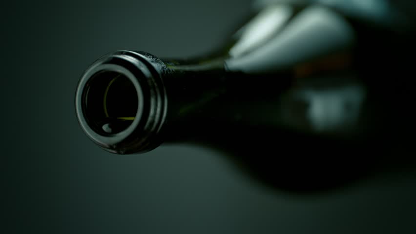 Super Slow Motion Shot of Camera Following White Wine Stream from Bottle into Glass at 1000fps.