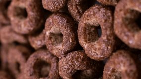 Vertical video format, Brown chocolate breakfast rings cereal falling down close up