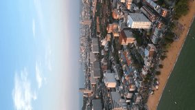 Vertical video. Aerial view of Pattaya's iconic coastline and city skyline at sunset. A popular tourist destination with stunning views in Thailand.