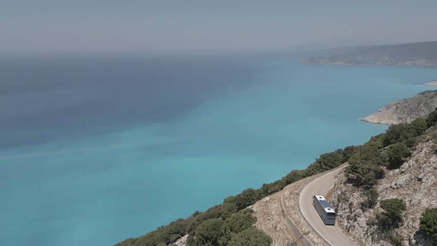 Aerial view of coach on coastal road near Agkonas, Agkonas, Kefalonia (Cephalonia), Ionian Islands, Greek Islands, Greece, Europe