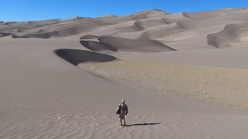 Silhouette of a tourist walking along a dune. Great Sand Dunes National Park, Colorado, USA