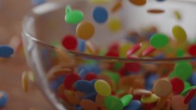 Many Chocolate Lentils Falling into a glass Bowl in slow motion - Powered by Shutterstock - Get 15% off with code: PIKWIZARD15