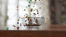 Side view of Chocolate Lentils Falling into a glass Bowl in slow motion - Powered by Shutterstock - Get 15% off with code: PIKWIZARD15