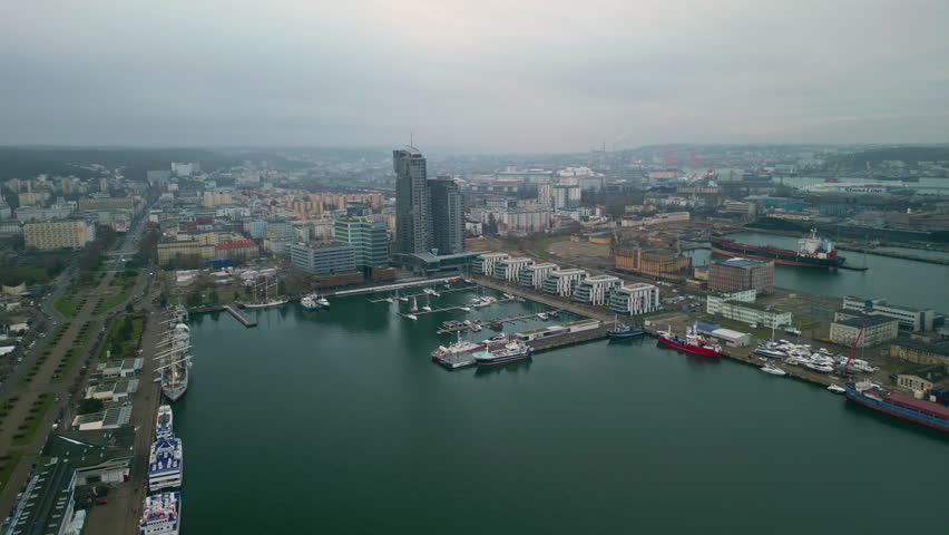 Majestic Aerial View of the Bustling Gdynia Port, with Cargo Vessels Unloading Their Valuable Goods. Drone Shot of the Vital Hub Connecting the City to the Global Maritime Network