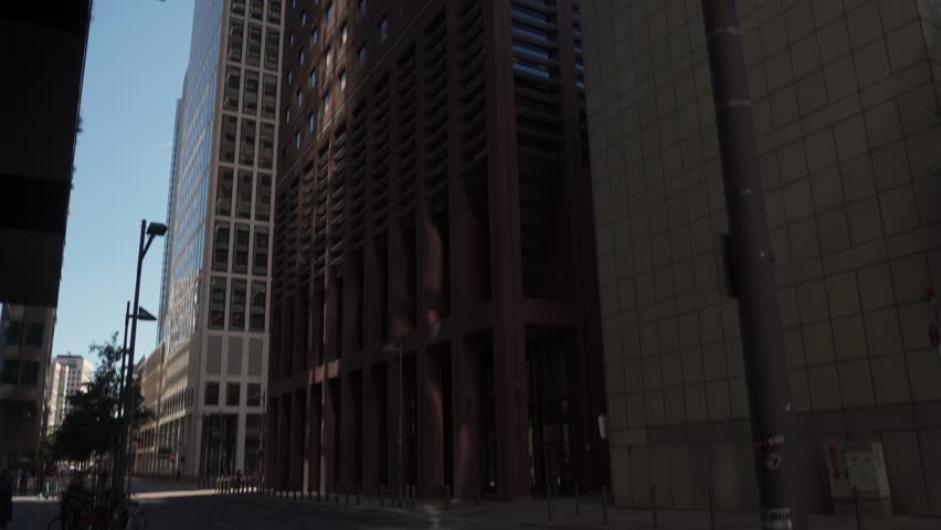 Smooth pan up onto a modern building in Frankfurt. View from the ground. Smooth pan up onto a modern building in Frankfurt
