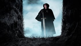 Open Grave Looking at Death with Sword 4K Loop features a view from inside an open grave of a disfigured figure in a black hood holding a broadsword in a loop. - Powered by Shutterstock - Get 15% off with code: PIKWIZARD15