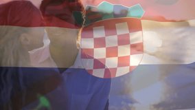 Composite video of waving croatia flag against caucasian couple embracing each other at the beach. Patriotism and motherhood concept - Powered by Shutterstock - Get 15% off with code: PIKWIZARD15