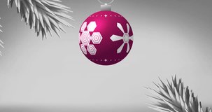 Animation of happy holidays text and christmas bauble on white background. Christmas, tradition and celebration concept digitally generated video.