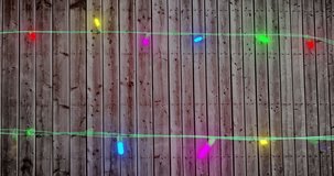 Animation of new year text over fairy lights on wooden background. New year, christmas, tradition and celebration concept digitally generated video.