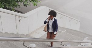 Animation of social media data processing over african american woman using smartphone in city. Global computing, digital interface and data processing concept digitally generated video.