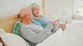Old couple on bed with tablet, phone and reading social media meme, post and relax in home together. Digital app, old man and woman in bedroom checking email, website or online with love in marriage. - Powered by Shutterstock - Get 15% off with code: PIKWIZARD15