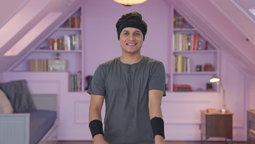 Happy Indian man doing arm stretching