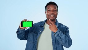 Man, presentation and phone green screen for marketing mockup, video advice or speaking of opportunity in studio. Face of african person pointing to mobile app and tracking markers on blue background