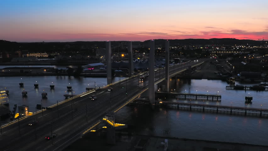 Sunset in the illuminated industrial Scandinavian city of Gothenburg, Sweden - high angle panorama view - pan right