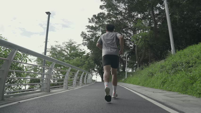 rear view of young asian man male athlete running jogging training outdoors in park Royalty-Free Stock Footage #1110225167
