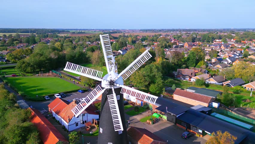 Above the historic site, video footage reveals the allure of Waltham Windmill and Rural History Museum in Lincolnshire, UK. Waltham Windmill is a fully functioning six-sailed windmill.