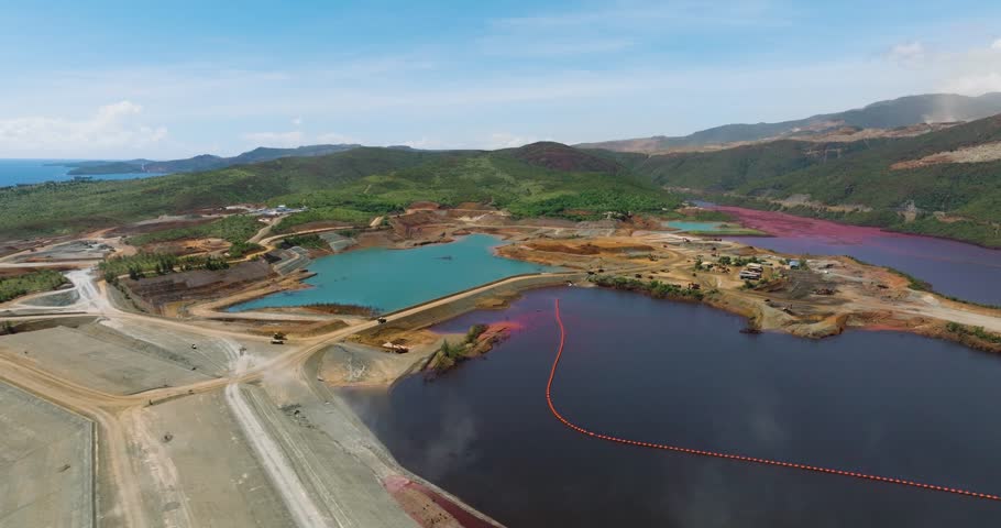 Drone survey of nickel mine with a dark red water. Natural resources. Mindanao, Philippines.