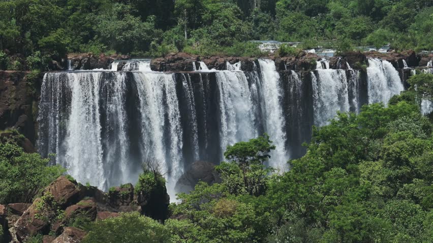 Amazing Picturesque Jungle Landscape and Row of Bright Waterfalls in Rainforest Nature Landscape, Beautiful Trees and Green Scenery with Large Group of Huge Waterfalls in Iguazu, Brazil Royalty-Free Stock Footage #1110232795