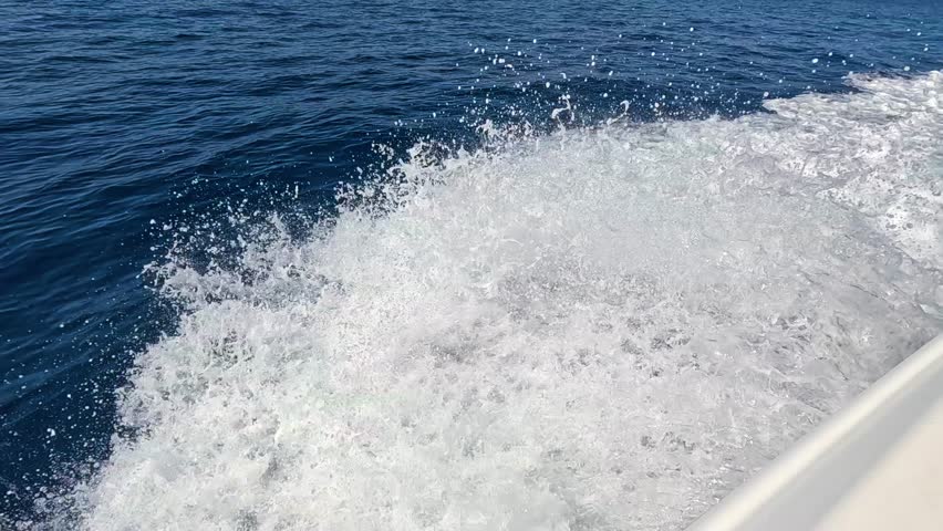 Speed Boat . Speed Boat floats on the beautiful red sea water. Slow Motion. A jet ski rushes across the surface of the sea. 