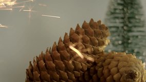 Christmas tree cone with a green new year tree in front of a beautiful flashing color background. Slow motion, 8K downscale, 4K.