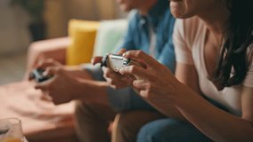 Hands video players holding consoles enjoying online game at home close up. Unrecognizable two gamers playing videogame using controllers indoors. Excited couple having fun competing in modern hobby. - Powered by Shutterstock - Get 15% off with code: PIKWIZARD15