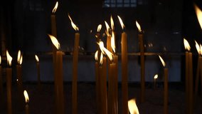 Tranquil Devotion: Candles in Slow Motion in the church. 