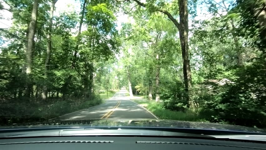Driving through suburban neighborhood on county road in summer in Northern America | Shutterstock HD Video #1110240591