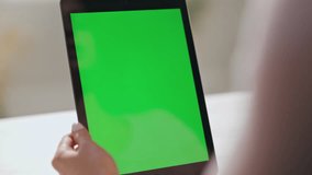 Woman talking to greenscreen tablet web camera having video conference indoors closeup. Unrecognizable businesswoman videocalling using mockup pad computer at office. Girl working at chroma key device - Powered by Shutterstock - Get 15% off with code: PIKWIZARD15