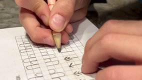 child writes in copybooks, close-up 4K video. High quality 4k footage
