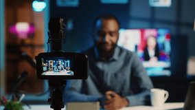 Content creator doing technology review of wireless portable speaker for online platforms channel. African american influencer presenting music playing device to his audience - Powered by Shutterstock - Get 15% off with code: PIKWIZARD15