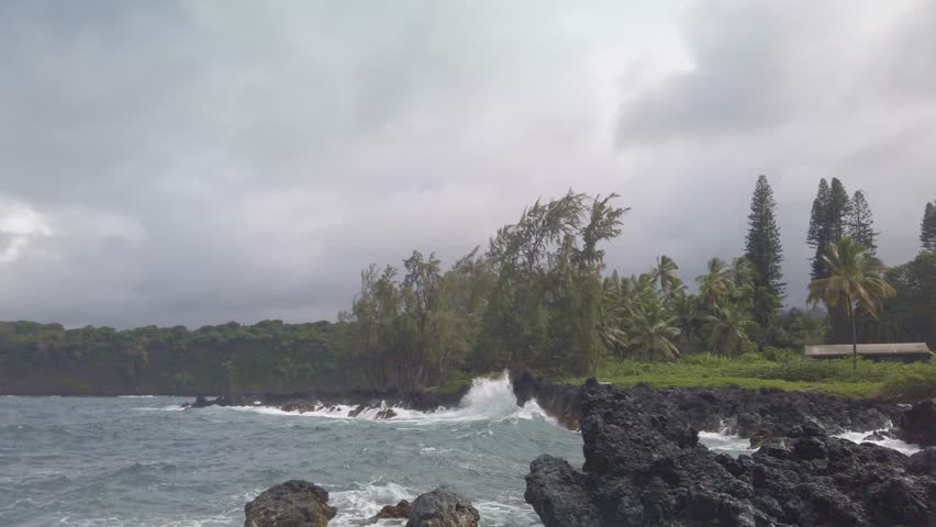 Gimbal close-up shot of strong waves hitting lava rock off the coast of Hana in Maui, Hawai'i. 4K at 60 FPS Slow Motion Royalty-Free Stock Footage #1110258691