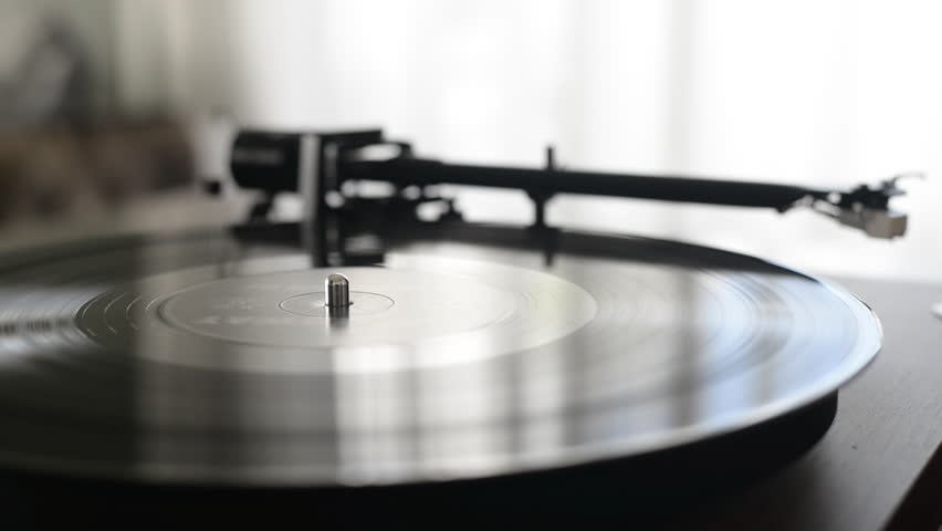 Hand turns on a vintage vinyl record. The needle rises from a vintage vinyl record. The vinyl record is spinning. The needle plays on a vintage vinyl record. Old turntable. Royalty-Free Stock Footage #1110261541