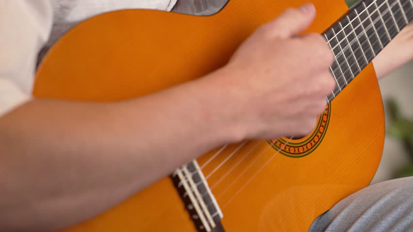 Close-up of a man playing the yellow guitar with his fingers Royalty-Free Stock Footage #1110265257