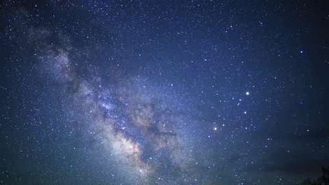 motion controlled astrophotography time lapse footage with dolly down, tilt down & pan right motion of Milky Way galaxy over desert landscape through dawn in Death Valley National Park, California